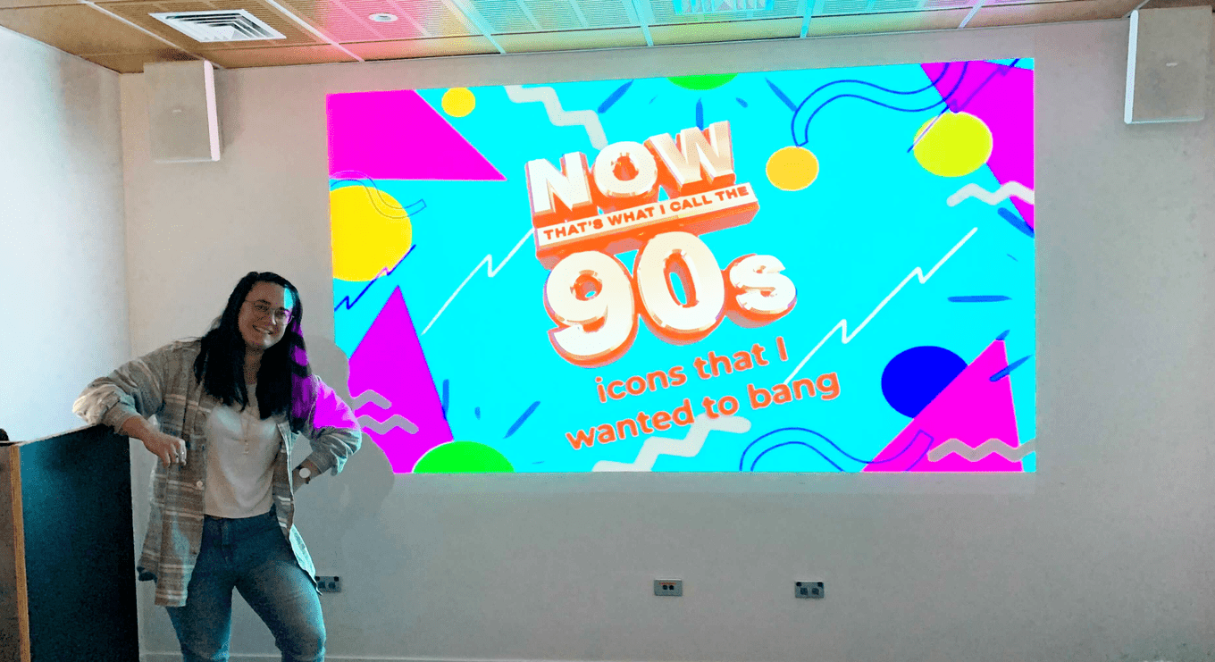 Chloe standing in front of a PowerPoint presentation about 90s icons