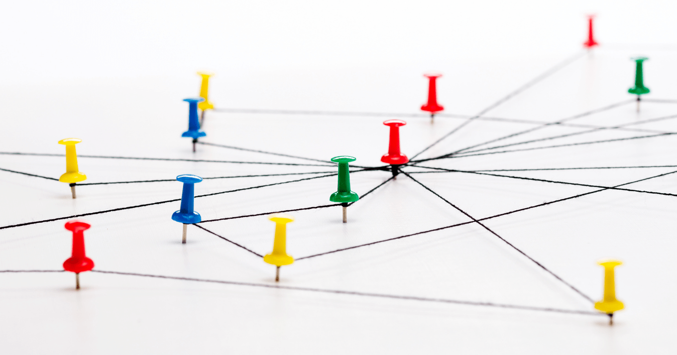 A bunch of push pins connected by string to represent networking in your career